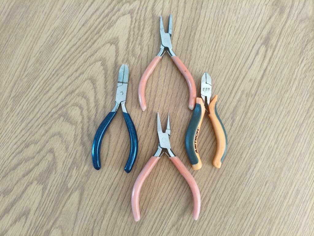 tools for making jewellery on on a wooden table. Jewellery making for beginners.