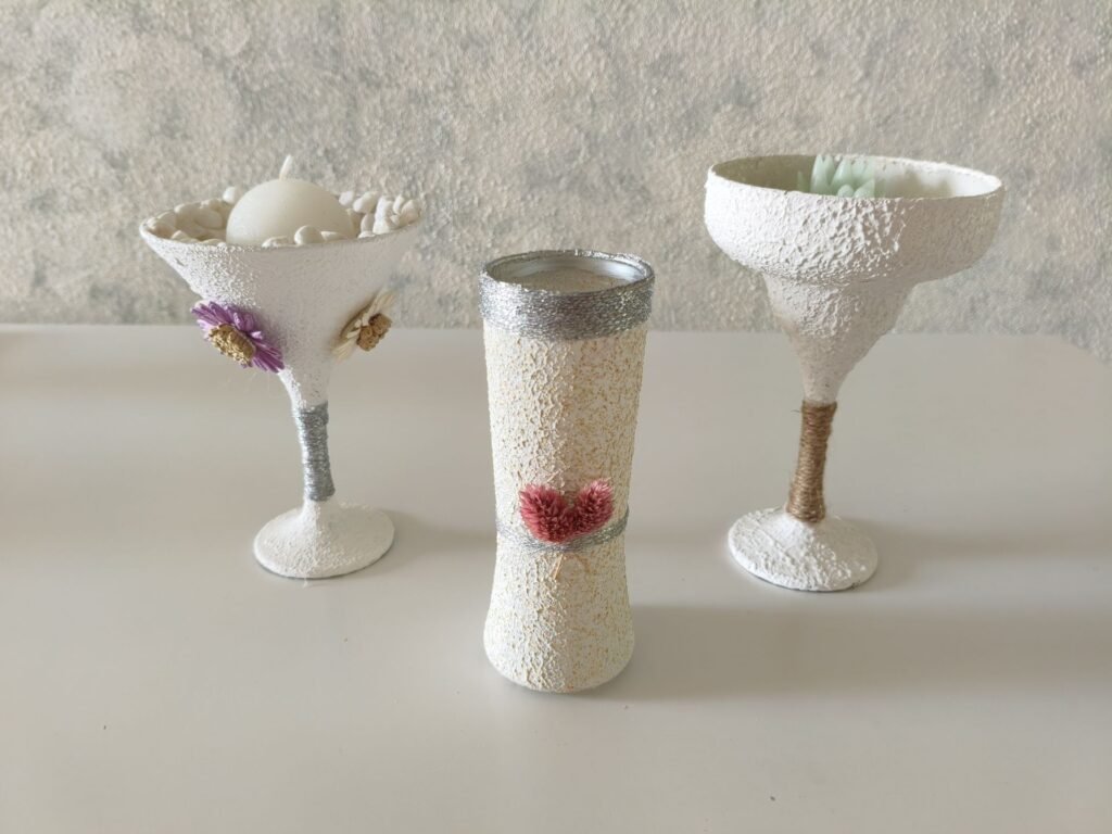 Three DIY glass vases with wall putty texture