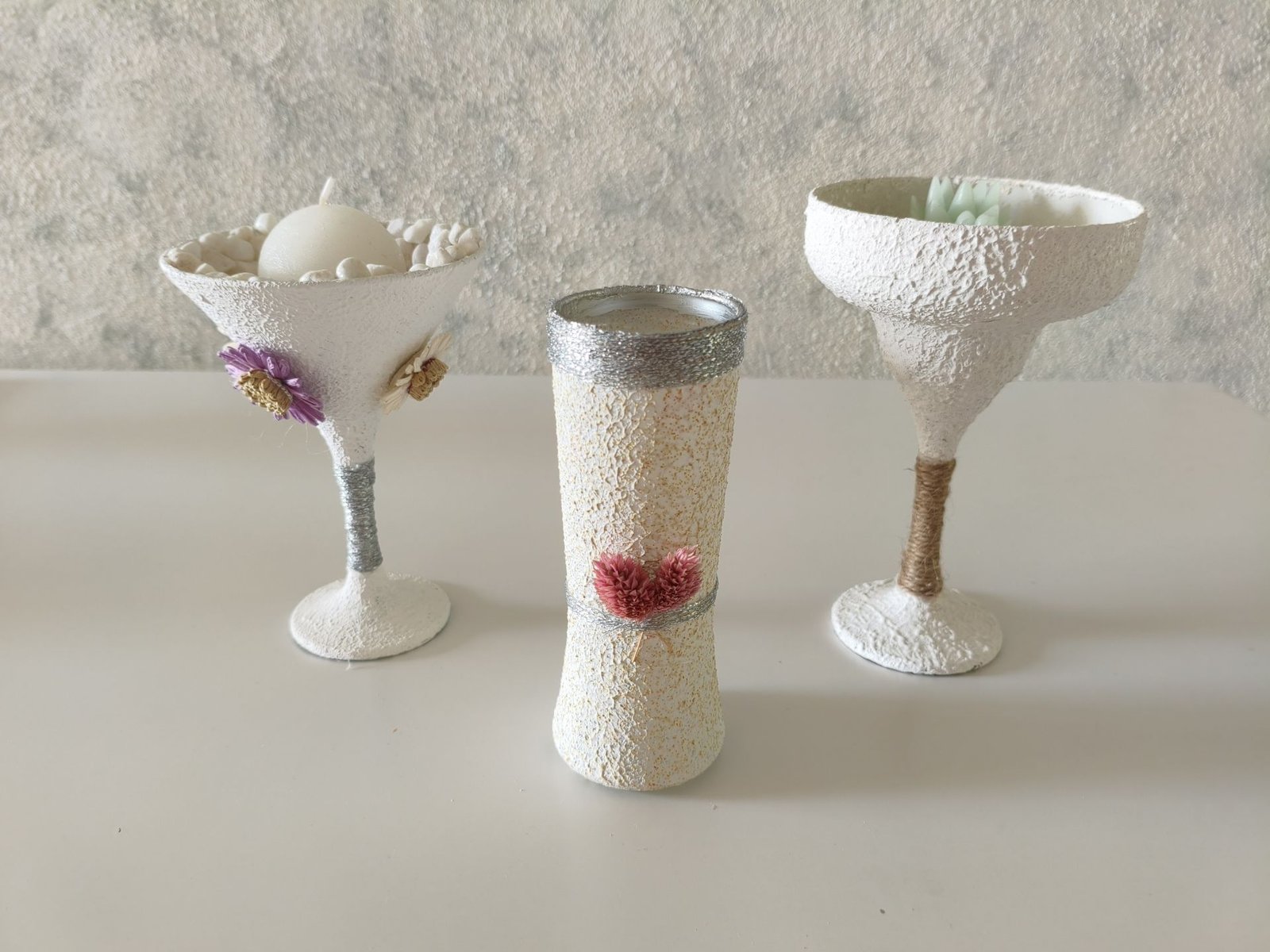 Three DIY glass vases with wall putty texture